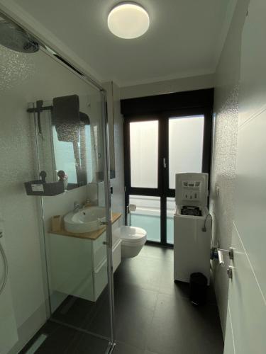 a bathroom with a toilet and a sink and a shower at Villa Sun&Sea in Komarna