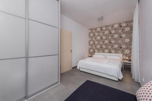 Postel nebo postele na pokoji v ubytování Apartments Lanterna