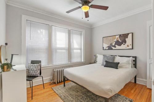 a bedroom with a bed and a ceiling fan at 1BR Calm & Cozy Apt in Lincoln Square - Eastwood 2S in Chicago