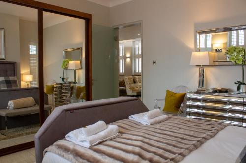 1 dormitorio con 1 cama grande y toallas. en Liberty at Utopia Penthouse by MGroupSA en Swansea