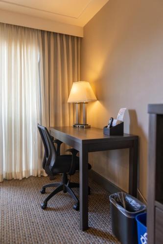 a desk with a lamp and a chair in a hotel room at GreenTree Inn & Suites Los Angeles - Alhambra - Pasadena in Alhambra