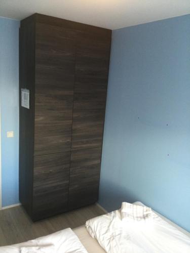 a bedroom with a large wooden closet in the wall at Reykjavík City Town Apartments in Reykjavík