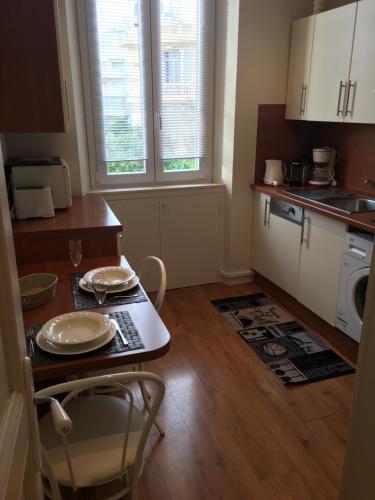 une cuisine avec une table et des chaises dans une cuisine dans l'établissement 2 pièces cannes centre, à Cannes