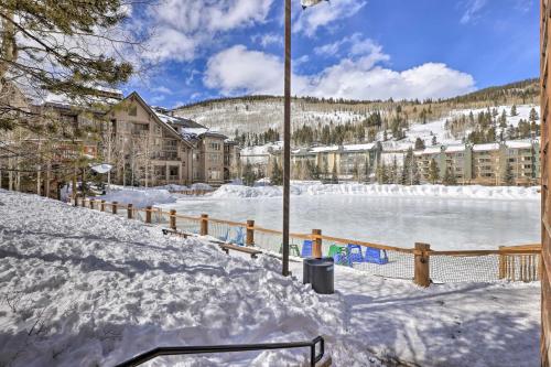 a snow covered yard with a river and buildings at Copper Mountain Condo Walk to American Eagle Lift in Copper Mountain