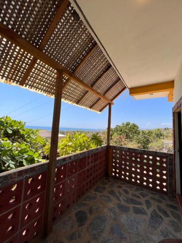 a deck with a pergola with a view at Casa Terranova in Puerto Escondido