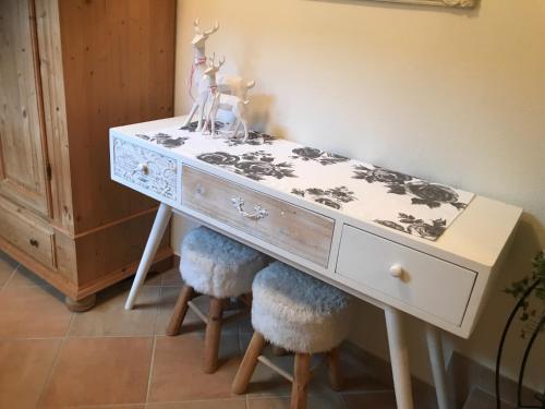 a dresser with two chairs under it with a table at Landhaus Aigner in Allhartsberg