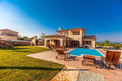 an estate with a swimming pool and a house at Villa Mare in Vrh
