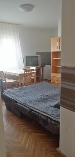 a bed sitting on the floor in a room at Belvárosi Vendégház in Miskolc