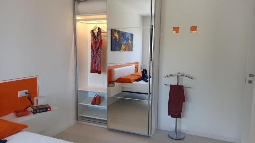 a room with an open refrigerator with a bed at Blue Sky Garda - Sunset in Malcesine