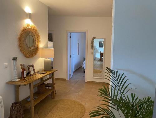 a room with a table and a mirror on the wall at Monte da Aparica in Galeguinha Grande