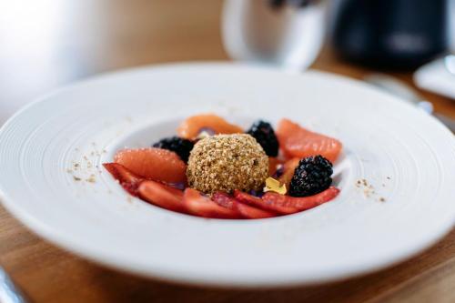 a white plate topped with fruit on a table at The Barn B&B Walla Walla in Walla Walla