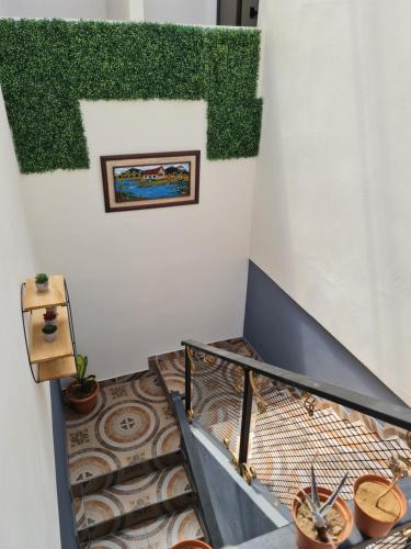 a staircase in a room with plants on the wall at Apartamentos Ave del Paraíso in Alajuela City