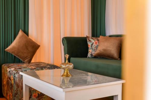 a living room with a couch and a table at Agafay Pearl Camp Marrakech in Marrakech