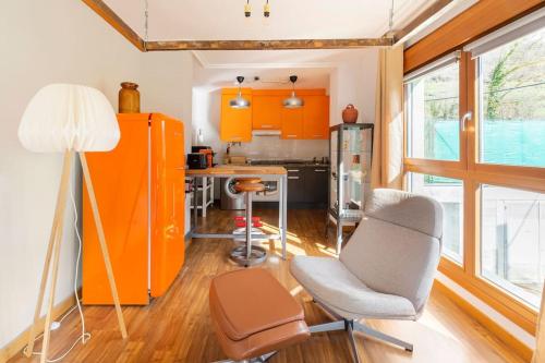 a kitchen with orange cabinets and a table and chairs at Loft Felechosa in Felechosa