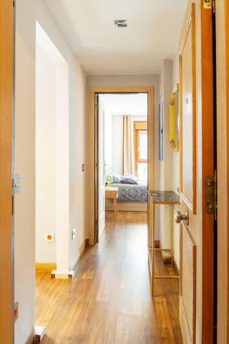 a hallway with a door open to a living room at Loft Felechosa in Felechosa