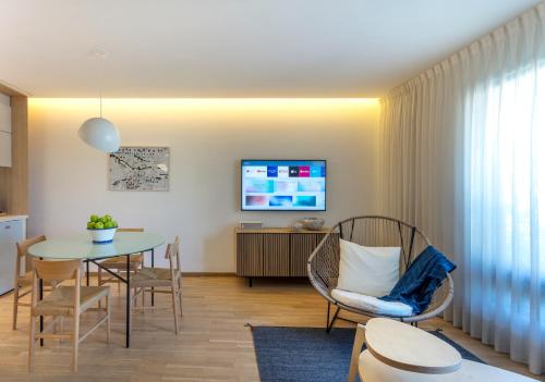 a living room with a table and chairs and a television at V65 Mx in Mexico City