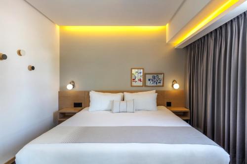 a bedroom with a large white bed and curtains at V65 Mx in Mexico City