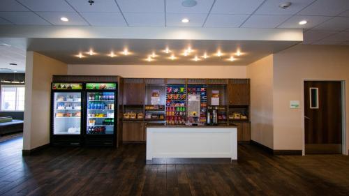 a lobby with a counter and a drink refrigerator at Holiday Inn Cody - Convention Center by IHG in Cody