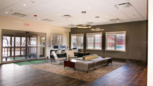 an office with a couch and a desk with a computer at Holiday Inn Cody - Convention Center by IHG in Cody