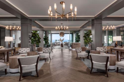 a lobby with chairs and tables and a chandelier at L'Auberge Del Mar Resort and Spa in San Diego