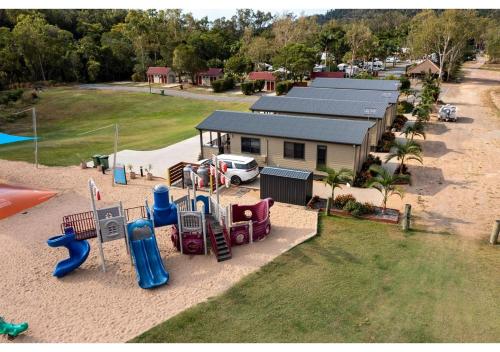 an aerial view of a playground in front of a house at Discovery Parks - Airlie Beach in Airlie Beach