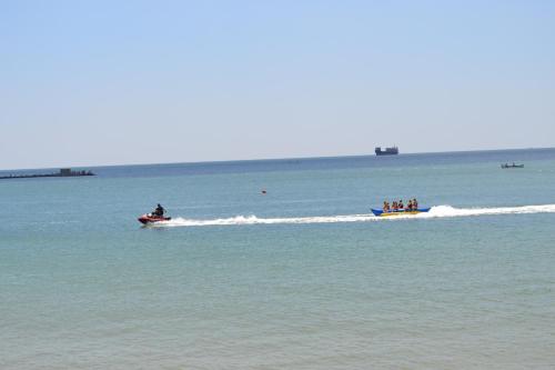 a group of people riding on boats in the water at Family Hotel Magnolia in Balchik