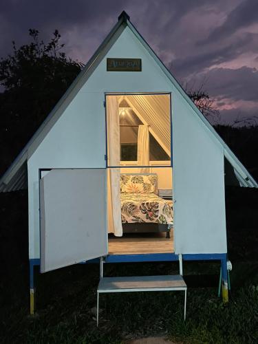 a blue tent with a bed inside of it at Cabaña Campestre Miraluna in Choachí