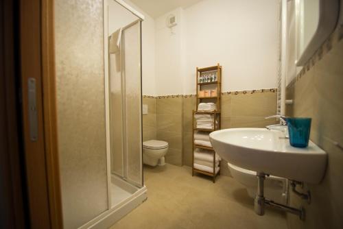 a bathroom with a toilet and a sink and a shower at Cosmopolitan Golf & Beach Resort in Tirrenia