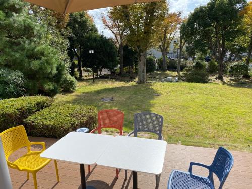 a group of chairs around a white table at 伊豆RONG in Ito