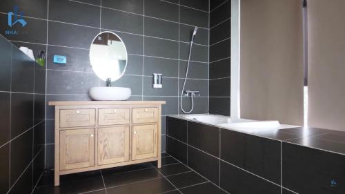 a bathroom with a sink and a mirror at The Luciola Tam Đảo - Venue Travel in Vĩnh Phúc