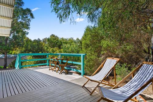 a deck with chairs and a table on it at Casa Capri - Aldinga Beach - C21 SouthCoast Holidays in Aldinga Beach