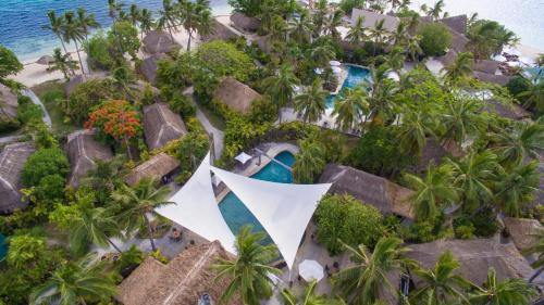 an aerial view of a resort with a pool and palm trees at Castaway Island, Fiji in Castaway Island