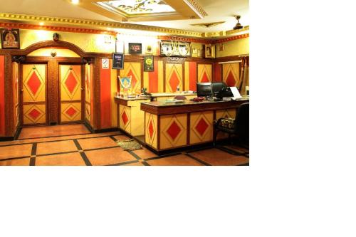 a room with a desk with a computer in it at Navanidhi Comforts in Bangalore