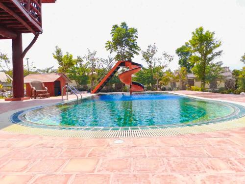 a small pool with a slide in the middle at Tayama Farm Khaoyai in Nakhon Ratchasima