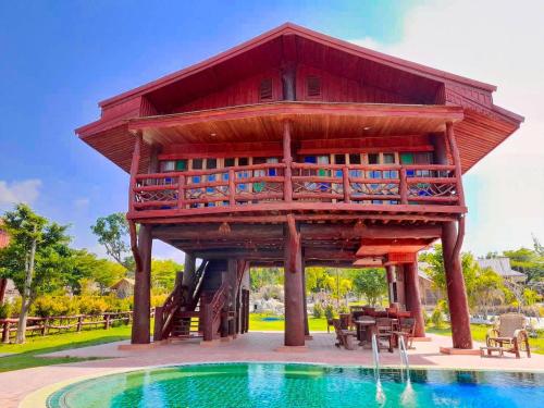 a tree house with a pool in front of it at Tayama Farm Khaoyai in Nakhon Ratchasima