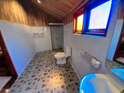 a bathroom with a toilet and a shower and a sink at Tayama Farm Khaoyai in Nakhon Ratchasima