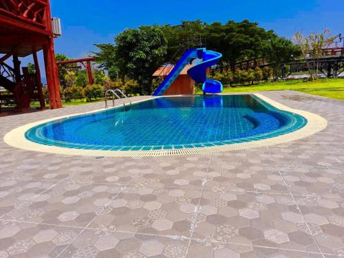 a small pool with a water slide in a playground at Tayama Farm Khaoyai in Nakhon Ratchasima