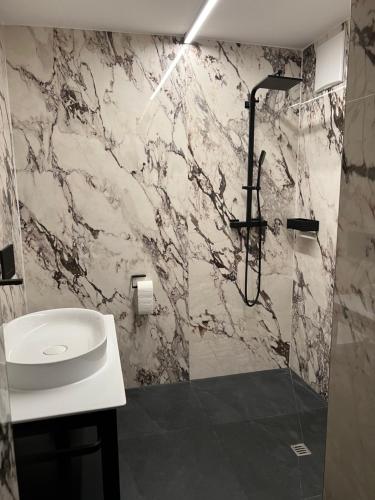 a bathroom with a shower and a sink at Zimmer & Appartements am Schloßplatz in Hohenems