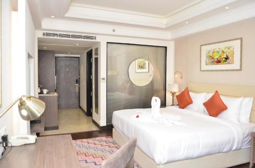 a bedroom with a large white bed and a bathroom at Ramada by Wyndham Kasauli in Kasauli