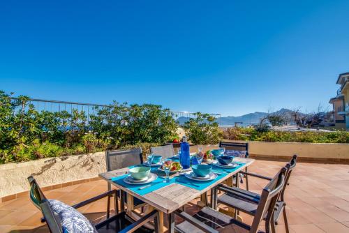 a wooden table with chairs on a patio at Ideal Property Mallorca - Ca sa Tati in Son Serra de Marina