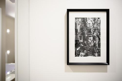 a framed picture of a city on a wall at Alma Suites in Naples