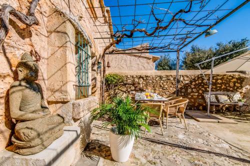 a statue of a woman sitting on the side of a building at Ideal Property Mallorca - Can Maria in Costitx