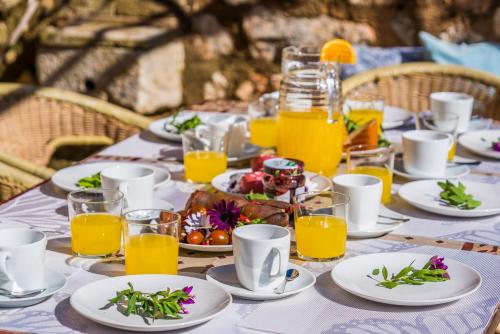a table with plates of food and glasses of orange juice at Ideal Property Mallorca - Can Maria in Costitx