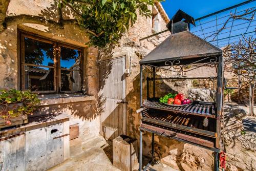 a cage filled with fruits and vegetables next to a window at Ideal Property Mallorca - Can Maria in Costitx