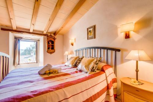 a bedroom with a bed with a wooden ceiling at Ideal Property Mallorca - Can Maria in Costitx