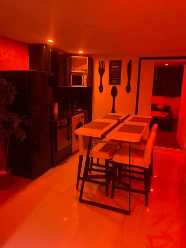 a kitchen with a table and chairs in a room at love love 23 in Villeurbanne