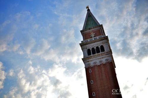 a clock tower with a sky in the background at Ca' Pedrocchi in Venice