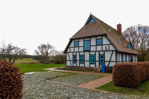 Casa blanca y azul con ventanas azules en Eulenhof, 
