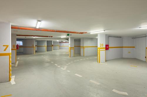 an empty parking lot with yellow dividers in a parking garage at Sun Spalato Residence in Makarska