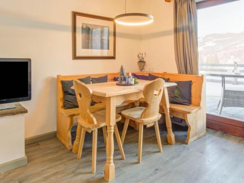 a dining room with a wooden table and chairs at Valley View Apartment near Skiing Area in Kirchberg in Tirol